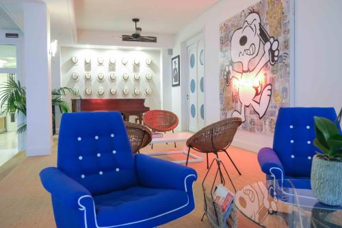 a living room with two chairs and a piano at Hotel Majestic in Lido di Jesolo