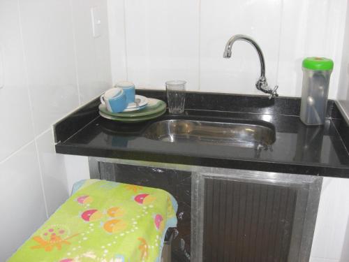 a kitchen counter with a sink and a plate at Aragão Botafogo Studio in Rio de Janeiro