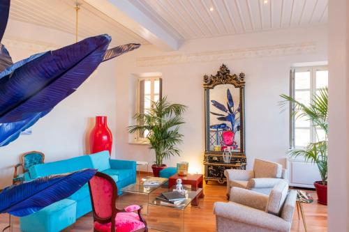 a living room with a blue couch and chairs at Villa Selena in Ermoupoli