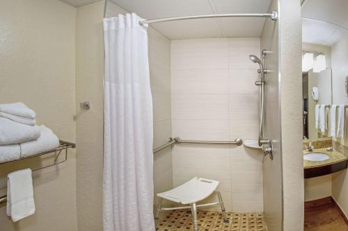a bathroom with a shower with a toilet and a sink at Comfort Inn & Suites Sarasota I75 in Sarasota