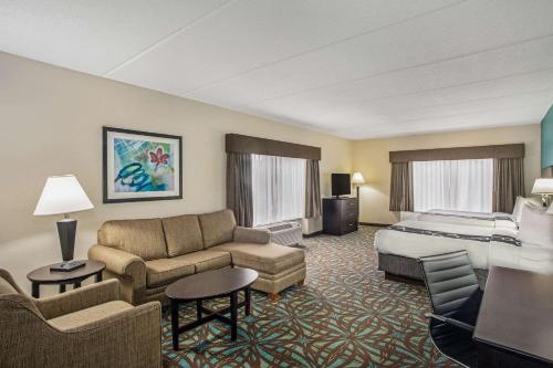a hotel room with a bed and a bed and a couch at Comfort Inn & Suites Sarasota I75 in Sarasota