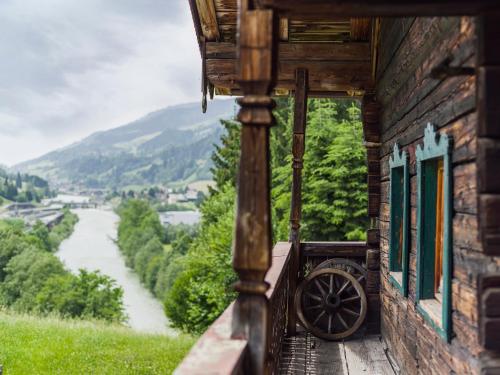 a building with windows and a view of a river at Chalet Wolfbachgut in Taxenbach