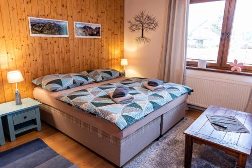 a bedroom with a bed with two towels on it at Ubytovanie Pri zvonici, Dlhá 149 Liptovský Mikuláš in Liptovský Mikuláš