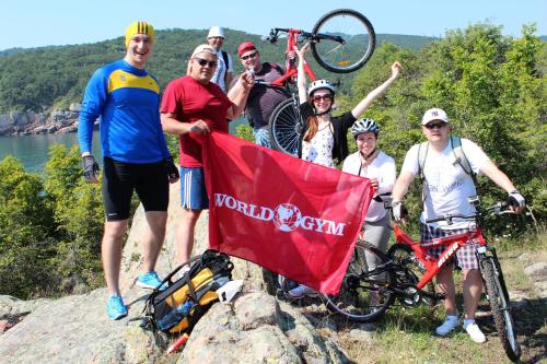 a group of people standing on a rock with a flag at Zapovedni Rai in Primorsko