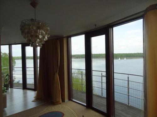 a room with large windows with a view of the water at Shuma in Dąbrowa Górnicza