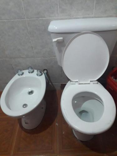 a bathroom with a white toilet and a sink at ALOJAMIENTO SANTY in Iruya