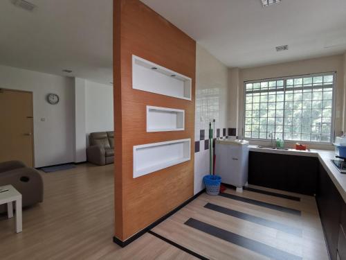 a kitchen with a refrigerator and a counter top at Eden 8pax 3Rooms apartment near Kuching Airport in Kuching