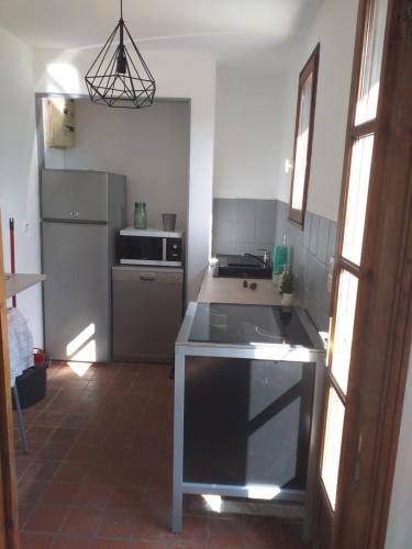 a kitchen with a sink and a stove top oven at La fadette in Argy