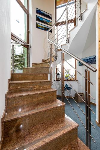 a set of stairs in a house with metal railings at Ubytovanie Pri zvonici, Dlhá 149 Liptovský Mikuláš in Liptovský Mikuláš