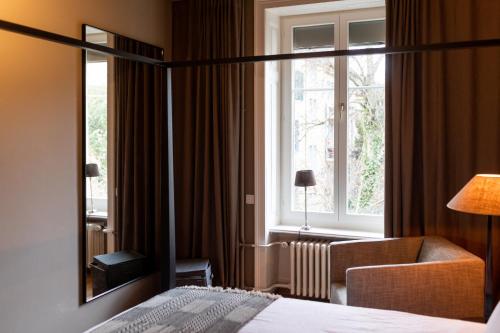 a hotel room with a bed and a window at The Pastorini in Zurich