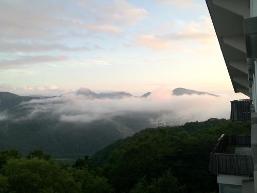 a view of the mountains in the clouds at Hotel Takimoto in Yamanouchi