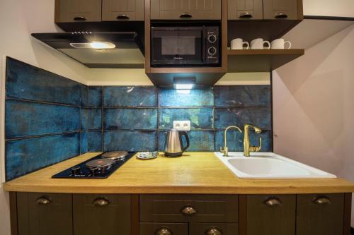 a kitchen with a sink and a microwave at Loft Apartments near Landscape Alley in Kyiv