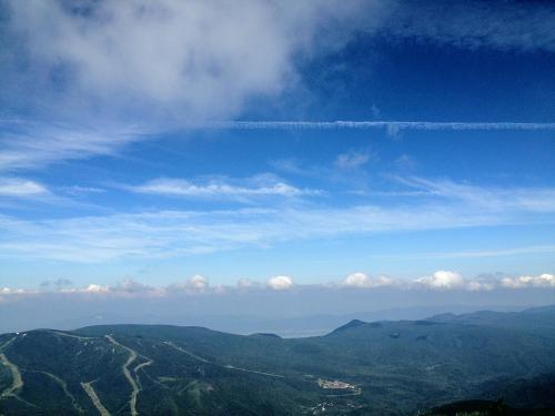 a view of the mountains with a blue sky and clouds at Hotel Takimoto in Yamanouchi