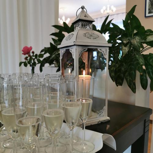 a group of glasses on a table with a candle at Hotel Cyprus in Grodzisk Mazowiecki