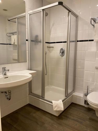 a bathroom with a shower and a sink and a toilet at Nordseehotel Wilhelmshaven in Wilhelmshaven