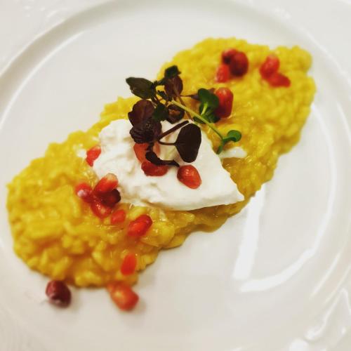 a white plate with a dessert on top of food at Hotel Rose in Villabassa