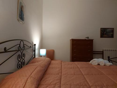 a bedroom with a bed with two towels on it at Borgo Saraceno in Sambuca di Sicilia