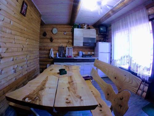 a wooden table and chairs in a room at Family Green in Sasovka