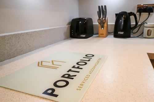 a sign on a counter with the word office on it at Portfolio Apartments - Welwyn Business Park in Welwyn Garden City