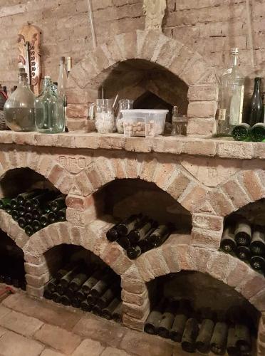 a stone wine cellar with a bunch of wine bottles at Ubytování U Špačků Pálava in Novosedly