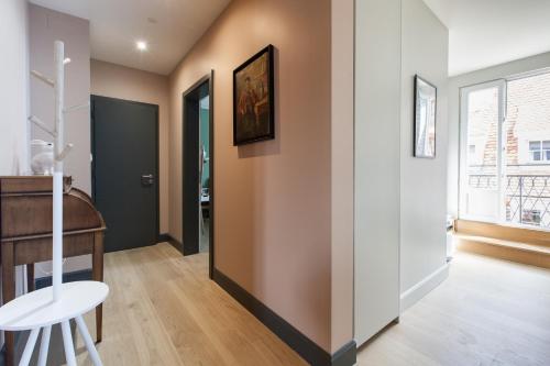 a room with a hallway with a table and a window at L'Appart du Quai avec Terrasse in Strasbourg