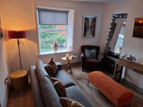 a living room with a couch and a window at Apartment 11, Mirfield, West Yorkshire in Mirfield