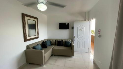 a living room with a couch and a door at My Home Hotel Punta Cana in Punta Cana