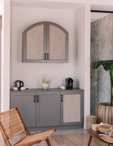 a gray cabinet in a living room with a chair at Teruar Urla in Urla