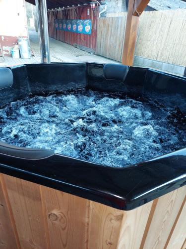 a jacuzzi tub with water in it at Szikla Vendégház in Istenmezeje