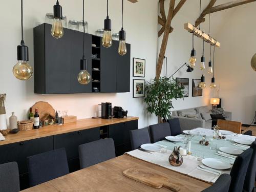 a dining room with a table and chairs at Ferme rénovée 300M2 La Casa JEB : Charme, Calme et Nature in Moncheaux