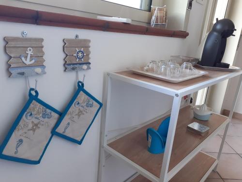 a small white table with some dishes on it at Castel Tauro Apartment in Taormina