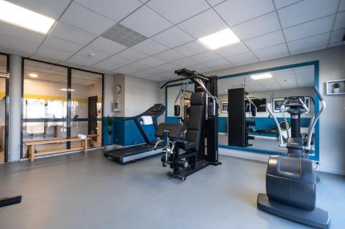 a gym with treadmills and elliptical machines at Clarion Aparthotel Toulouse Blagnac Airport in Blagnac