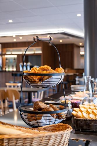 a tiered plate of pastries on a table at Clarion Aparthotel Toulouse Blagnac Airport in Blagnac