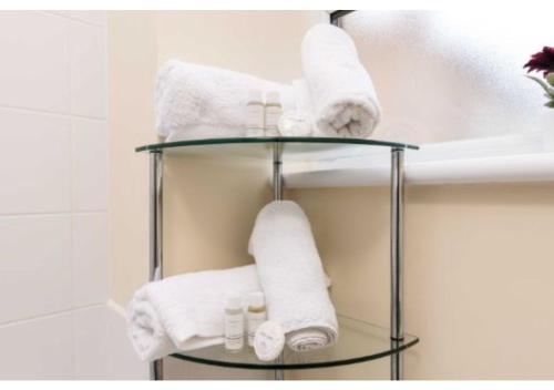 a towel rack in a bathroom with towels at Sublime Stays Coventry- Jenner Pet Friendly Apartment with Parking in Coventry