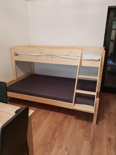 a bunk bed with a ladder in a room at Apartma Rogla Gaber 63 in Zreče