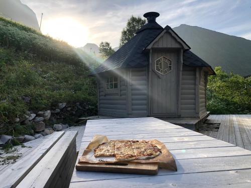a pizza on a cutting board on a table at Vacation Home in Fjordgård with views of Segla and the Fjord in Fjordgård