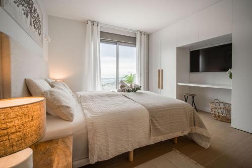 a bedroom with a bed and a large window at Casa Carolina - This One in Higuerón with Quality and Peace in Mijas