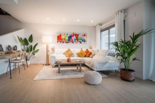 a living room with a white couch and a table at Casa Carolina - This One in Higuerón with Quality and Peace in Mijas
