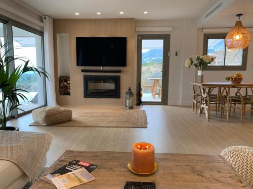 a living room with a fireplace and a tv at Casa Carolina - This One in Higuerón with Quality and Peace in Mijas