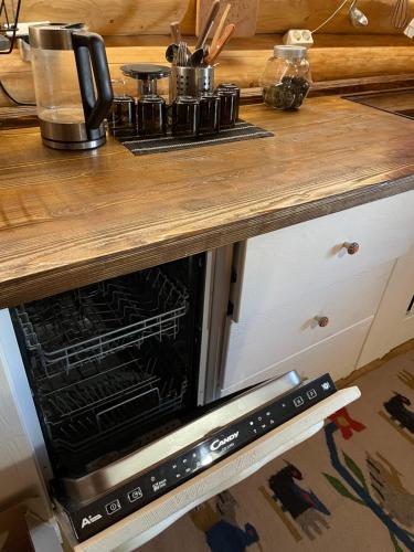 an oven in a kitchen with a wooden counter top at Будиночок-зруб в центрі Пилипця in Pilipets