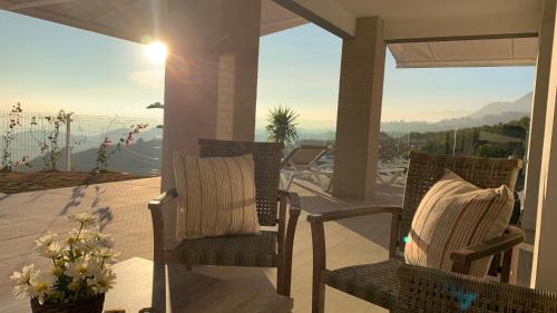 two chairs on a porch with a view of the ocean at Casa Carolina - This One in Higuerón with Quality and Peace in Mijas