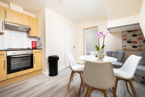 a kitchen and dining room with a table and chairs at Charmstay King's Cross in London