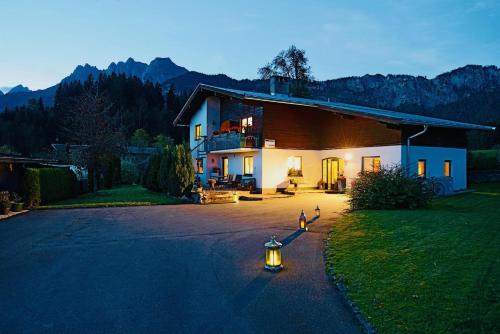 a house with a fire hydrant in the middle of a driveway at Ferienhaus Chalet Kitzalp in Sankt Johann in Tirol
