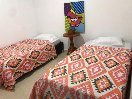 dos camas sentadas una al lado de la otra en una habitación en Apartamento Cómodo, en Ríohacha