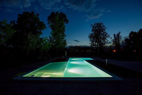 a swimming pool in a backyard at night at Villa Berrettini in Marano Vicentino