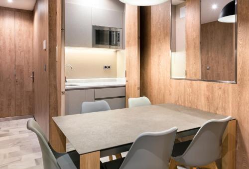 a kitchen and dining room with a table and chairs at Hotel San Pablo Sevilla in Seville