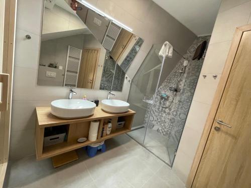 a bathroom with two sinks and a shower at Casa Valley Paradiso - Jahorina in Jahorina