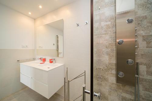 a bathroom with a white sink and a shower at Linara in San Juan de los Terreros