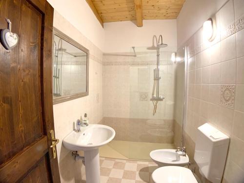 a bathroom with a sink and a toilet at Maso Azzurro Chalet in Stenico