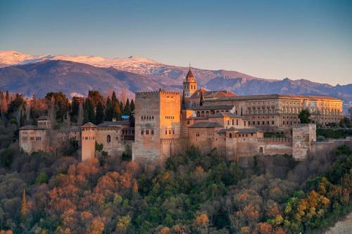 a large castle on top of a hill with trees at Casa Carolina - This One in Higuerón with Quality and Peace in Mijas